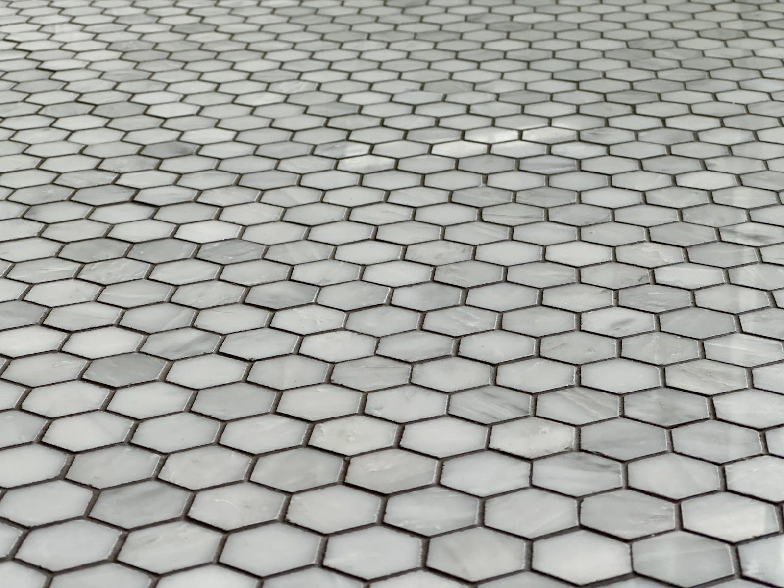 A close view of hexagonal floor tiles and their grout lines