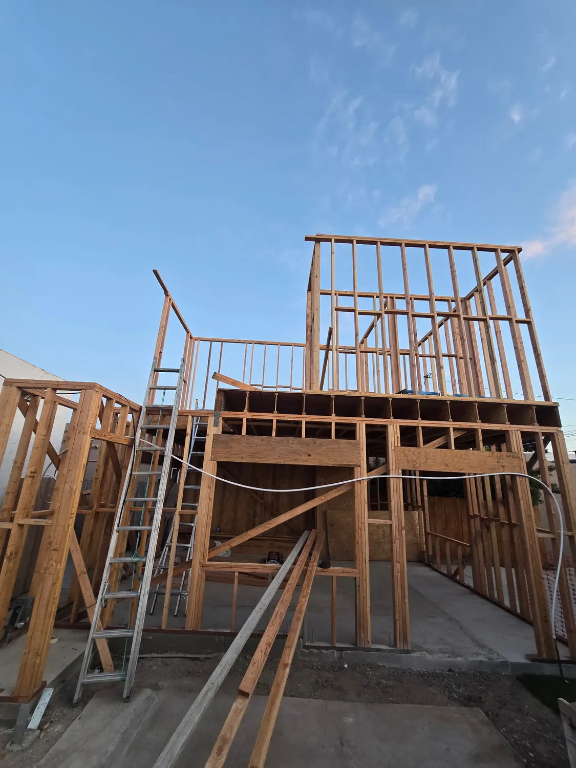 A two-story unit framed in timber against an evening sky, with ladders up to the second floor